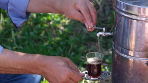 The man pours tea from the samovar Stock Footage 293978162