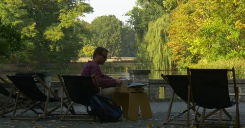 Man Pours Tea From The Teapot Man Sits In The Deckchair With Cup In His Hands Stock Footage 56065795