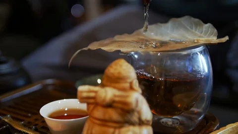 Man pours tea through a sieve. Stock Footage