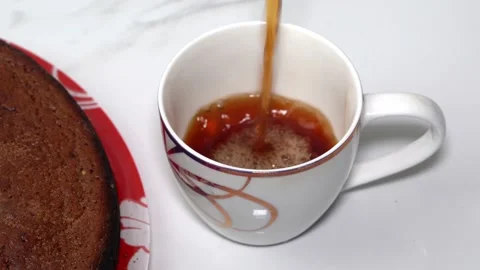 Man pours tea into a white cup Stock Footage 159440648