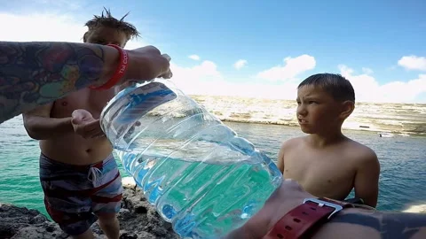 Man pours water on the hands of another man and he washes his face Stock-Footage 102031952
