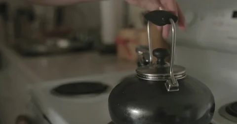 Man pours water into tea kettle Stock Footage 78038175