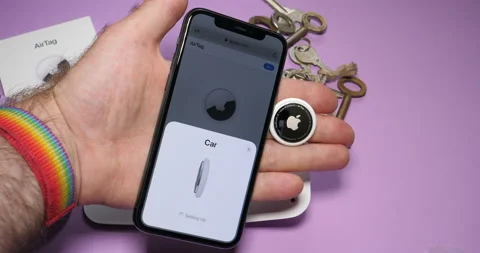 Man pov setting up AirTag setup on the iPhone display Stock Footage 153945094