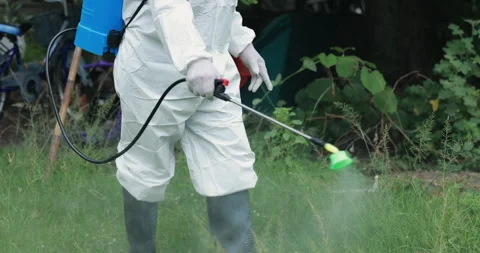 Man with PPE suit using chemicals disinfecting cleaning the house. Stock Footage 287853904