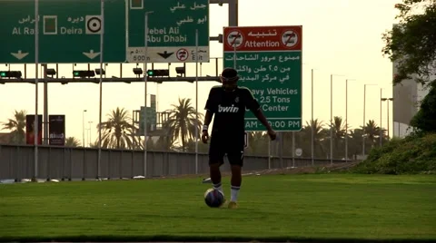 Man practice with ball, play alone at grass plot, kick ball with legs and knees Stock Footage 60127974
