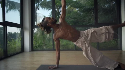 Man practice full side plank wit big toe yoga pose in studio rapid slow motion Stock Footage 89720193