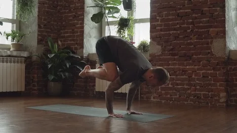 Man practice yoga hand standing pose in studio. Sport and lifestyle concept Stock Footage 116099531