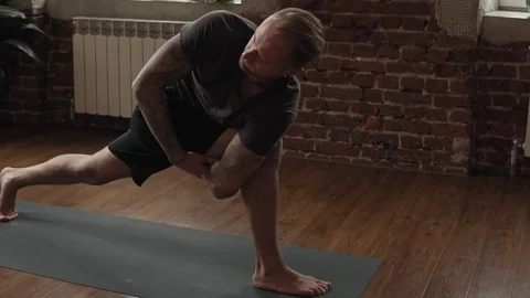 Man practice yoga pose in studio with brick wall. Healthy lifestyle concept Video stock 107103545