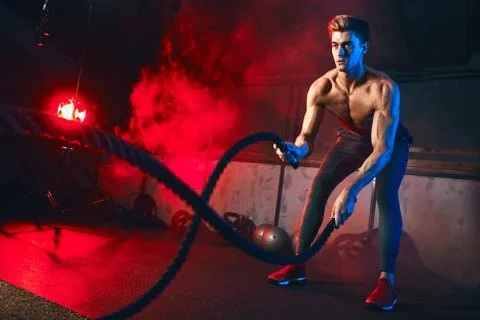 Man practices Battle Rope Exercise, great for improvement of Athletic Training Stock Photos
