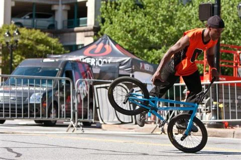 Man practices flatland bmx tricks before competition Stock Photos