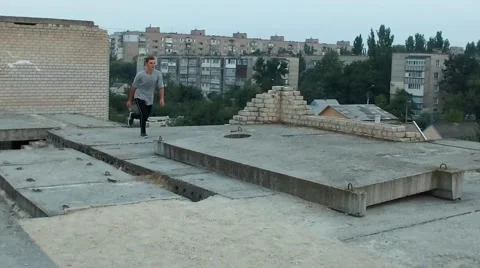 Man practices flips, jumps and free running on the roof Stock Footage 67314859