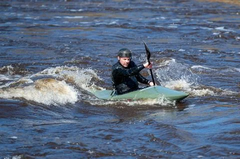 A man practices kayaking on the rapids of the Gauja river, Valmiera, Latvia Stock Photos