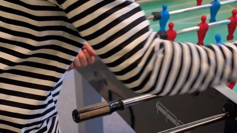A man practices kicker table football throws, Recreation and leisure concept Stock Footage 306286294