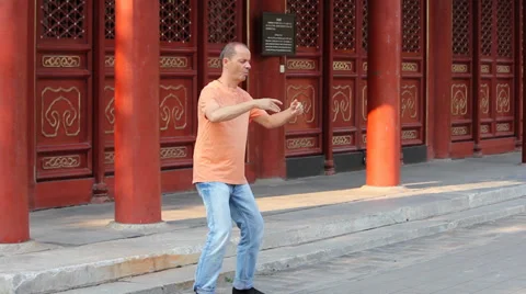 Man practices Qi Gong,a system of deep breathing exercises in Jingshan park Stock Footage 36766387