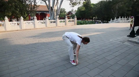 Man practices Qi Gong,a system of deep breathing exercises in Jingshan park Stock Footage 36789454