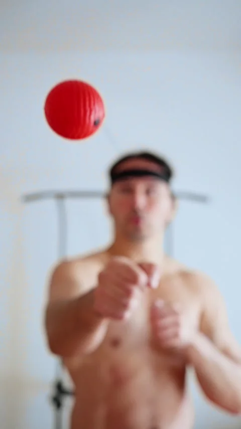 Man practices visual reflexes at home, man performs reaction drills using red Stock Footage 321611492
