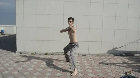 Man practices yoga on the roof. Complex military exercises ninja. Stock Footage 8569271