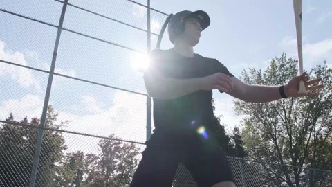 Man practicing baseball batting techniques with helmet at local field Stock Footage 312677876