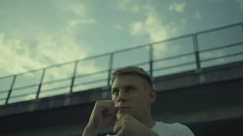 Man Practicing Boxing Moves under a Bridge Stock-Footage 313957832