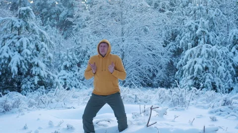 Man practicing breathing exercise outdoors in winter forest Stock Footage 335193774