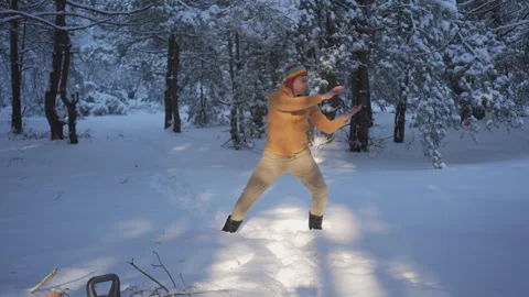 Man practicing breathing exercise in snowy forest landscape Stock Footage 334922063