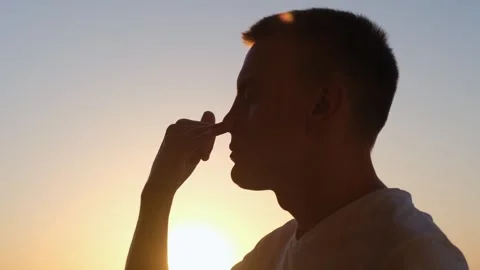 Man practicing controlled breathing technique at sunset. Pranayama and yoga Video stock 251588603