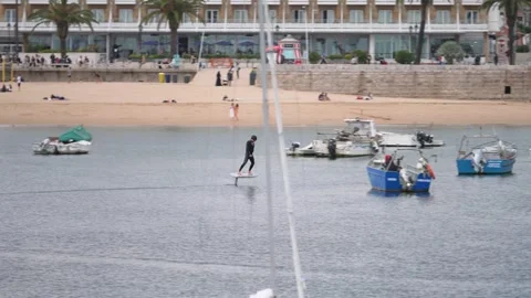 Man Practicing eFoil Surf at Cascais Beach Stock Footage 273235049