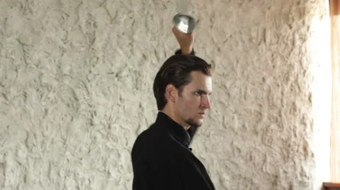 Man practicing elements of tai chi. The man rotating steel swords around a body 库存影片 64463525