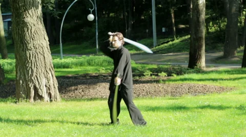 Man practicing elements of tai chi. A man rotating steel swords around a body HD Stock Footage 65214540