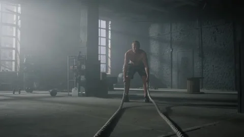 Man practicing exercise with battle ropes. Sportsman doing functional training Video stock 157435483