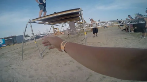 Man Practicing Free Running on the Beach and Shooting at the Camera All Around Stock Footage 60690121