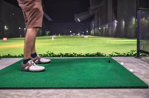 A man practicing with golf swing on golf course at golf driving range Stock Photos