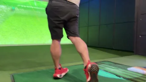 Man Practicing Golf Swing in Indoor Simulator Bay Stock Footage 324349822