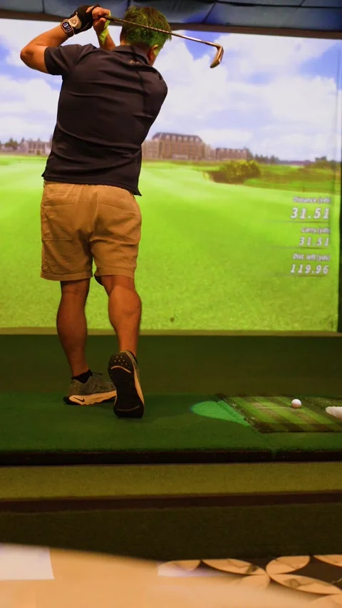 Man Practicing Golf Swing in Indoor Virtual Golf Simulator Stock Footage 334313724