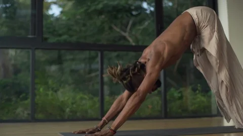 Man practicing handstand yoga pose in studio at sunrise rapid slow motion Stock Footage 89716091