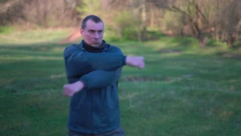 Man Practicing Karate in the Woods in the Early Morning in the Spring,ready to Stock Footage 74695359