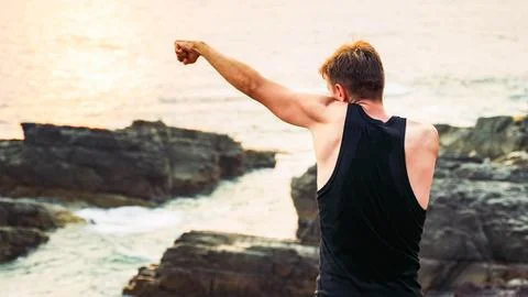Man practicing a left punch in boxing on the coast Stock Photos
