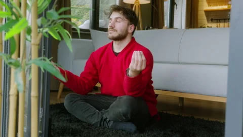 Man Practicing Mindfulness Meditation at Home in a Peaceful Environment  Re.. Stock Footage 303927981