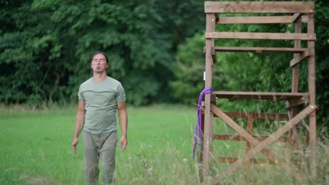 Man is practicing physical activities near a wooden structure. Outdoors Stock Footage 279272941