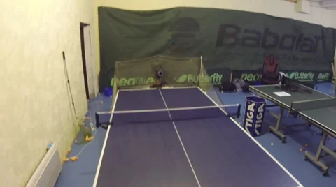 Man practicing to play tennis with robot serving of tennis balls Video stock 64213525