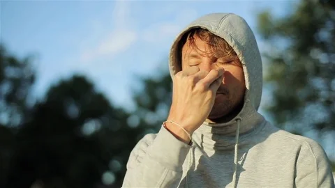 Man practicing pranayama close up slow motion. Breath control pressing nostrils  Stock Footage 79975267