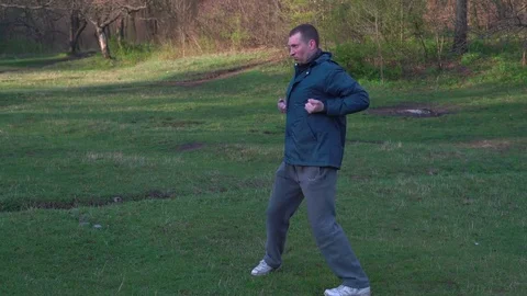 Man Practicing Qigong in a Clearing in the Woods While Doing Breathing Stock Footage 74694158