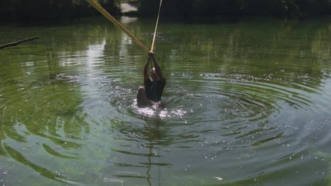 Man practicing slackline over the surface of the river 스톡 동영상 140683938