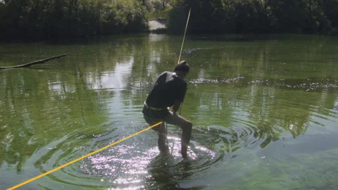 Man practicing slackline over the surface of the river 스톡 동영상 140683959