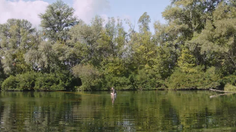 Man practicing slackline over the surface of the river 스톡 동영상 140690027