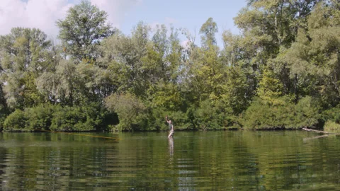 Man practicing slackline over the surface of the river 스톡 동영상 140690490