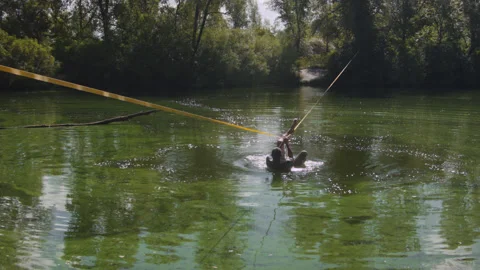 Man practicing slackline over the surface of the river 스톡 동영상 140760851