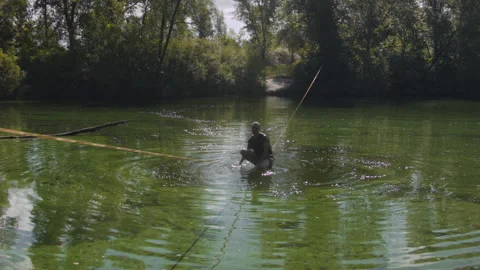 Man practicing slackline over the surface of the river 스톡 동영상 140761007