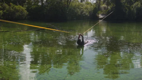 Man practicing slackline over the surface of the river 스톡 동영상 140761223