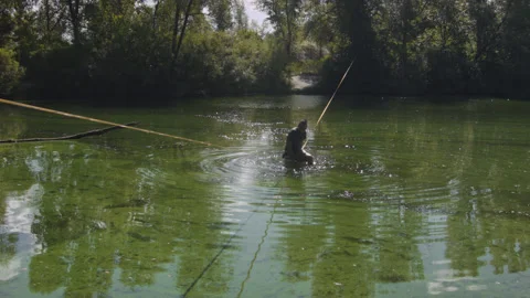 Man practicing slackline over the surface of the river 스톡 동영상 140761268